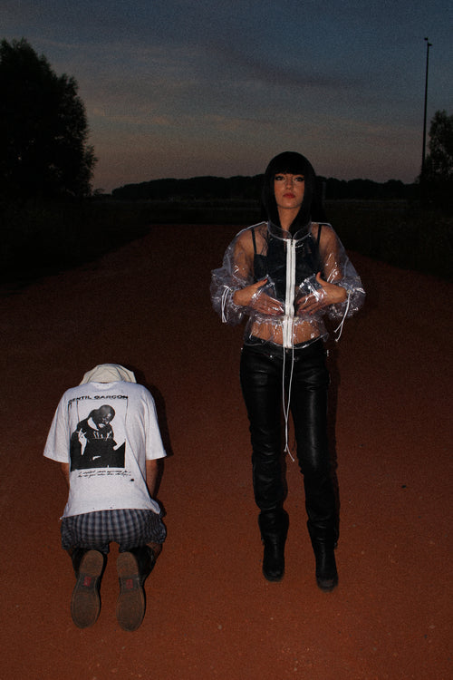 TRANSPARENT PVC CROPPED JACKET WITH A HIGH COLLAR, WHITE FRONT ZIP, ADJUSTABLE DRAWSTRINGS, RELAXED FIT AND CLEAR VINYL CONSTRUCTION.