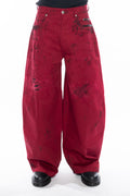 RED HAND-DYED OVERSIZED CURVED-LEG JEANS WITH A LOW-RISE WAIST, BLACK HAND-PAINTED DETAILS, FIVE-POCKET CONSTRUCTION, BUTTON FLY AND SILVER HARDWARE.