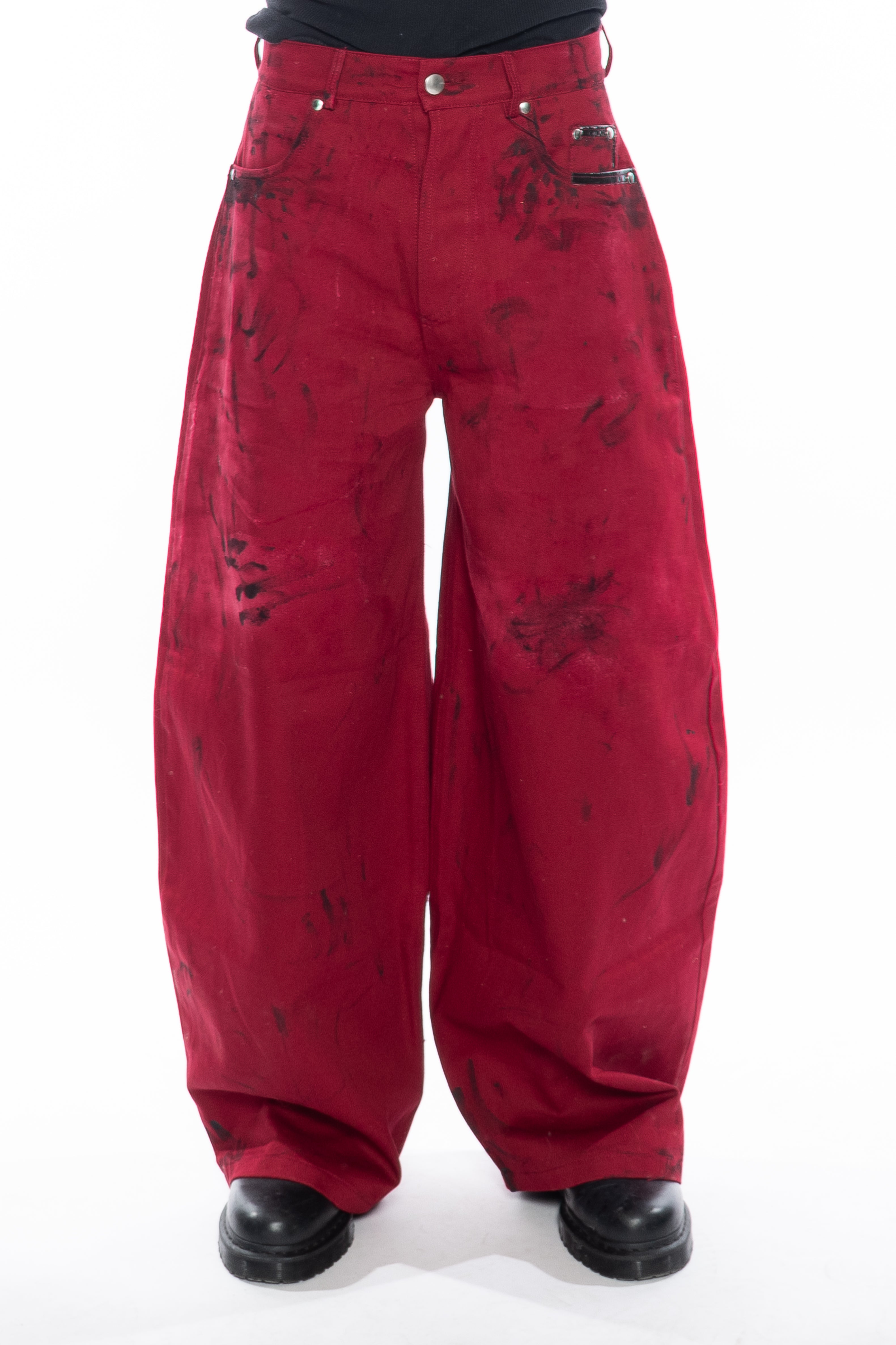 RED HAND-DYED OVERSIZED CURVED-LEG JEANS WITH A LOW-RISE WAIST, BLACK HAND-PAINTED DETAILS, FIVE-POCKET CONSTRUCTION, BUTTON FLY AND SILVER HARDWARE.