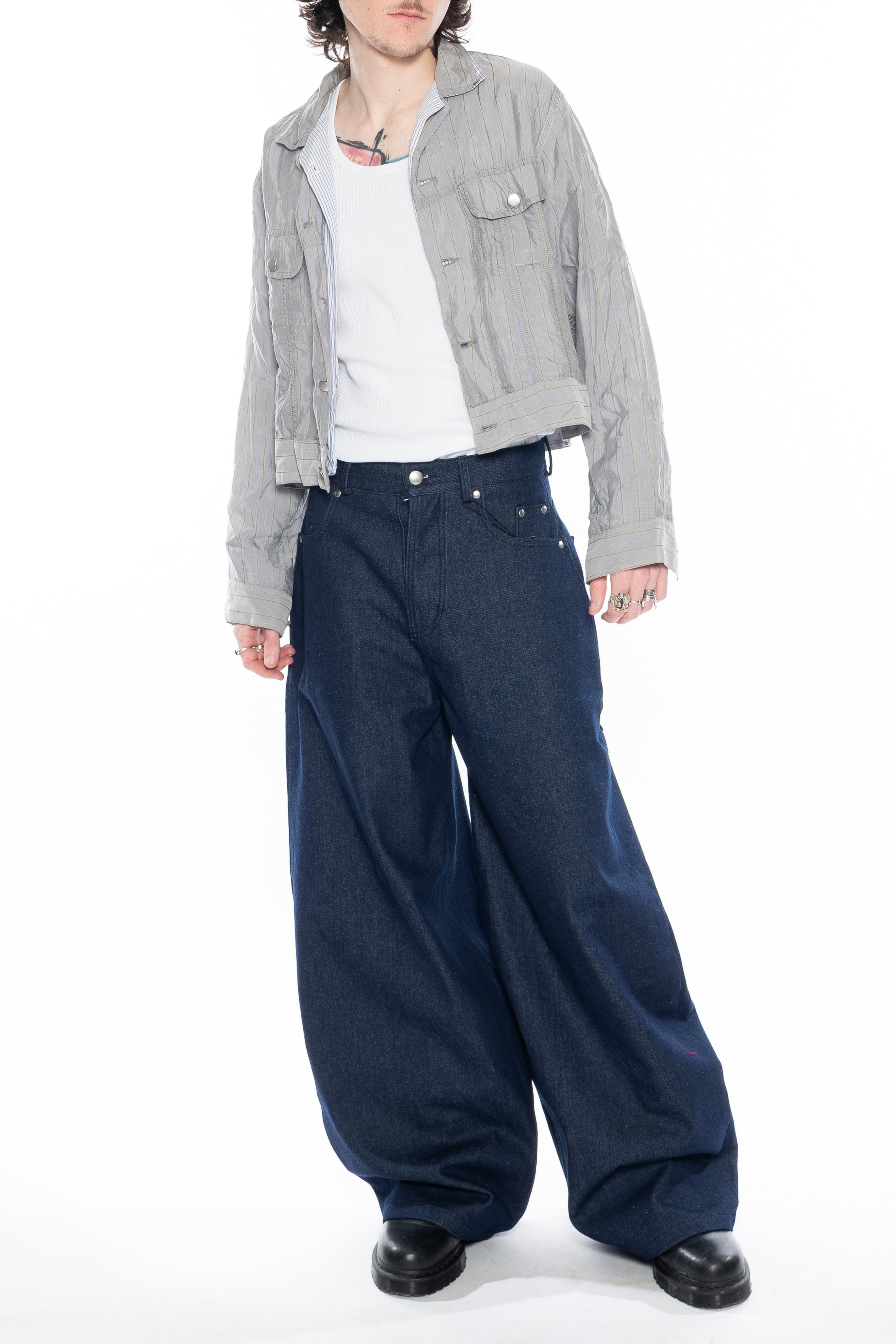 RAW INDIGO OVERSIZED CURVED-LEG JEANS WITH A LOW-RISE WAIST, FIVE-POCKET CONSTRUCTION, BUTTON FLY, SILVER HARDWARE AND A RELAXED SILHOUETTE.