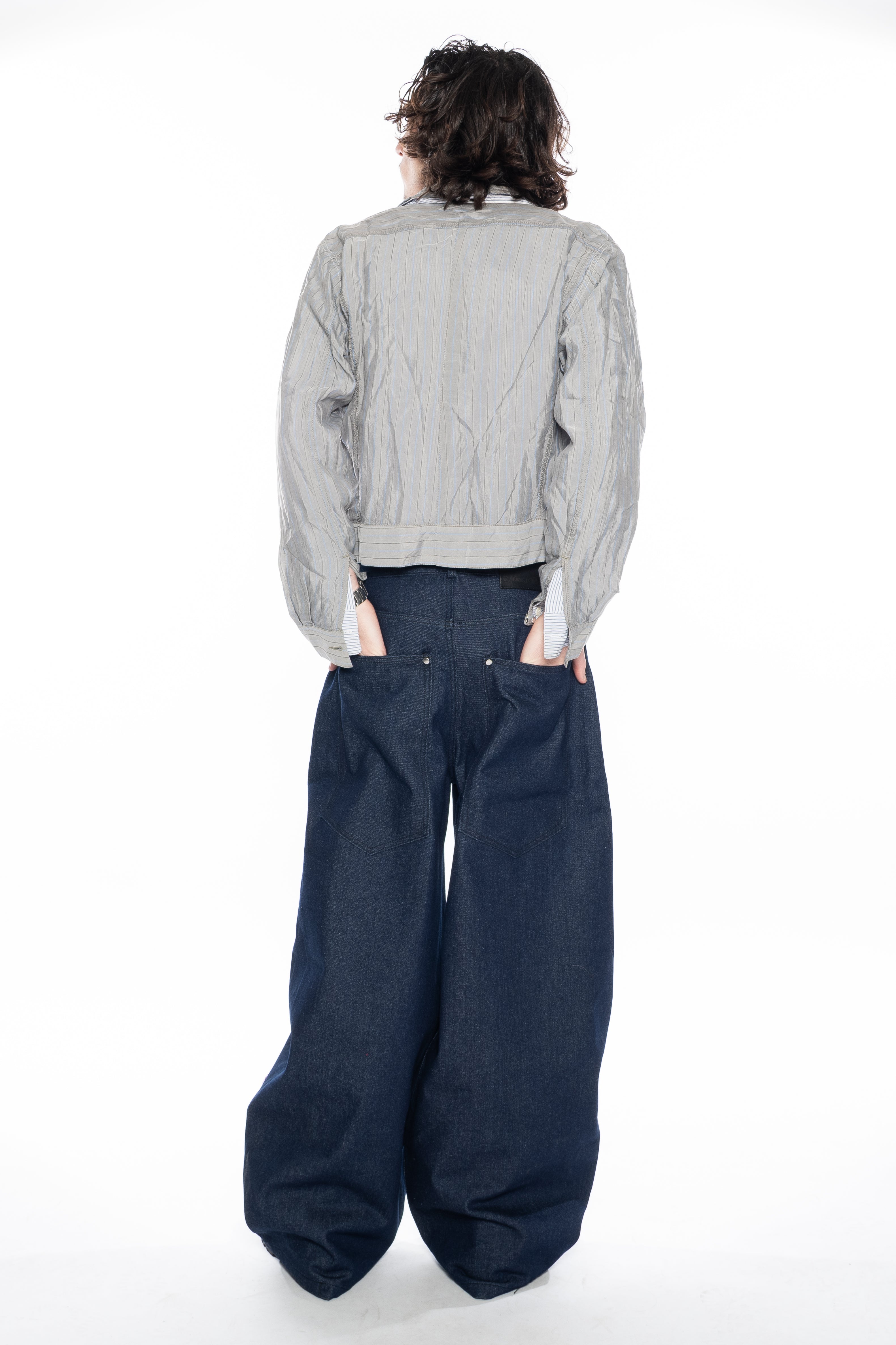 RAW INDIGO OVERSIZED CURVED-LEG JEANS WITH A LOW-RISE WAIST, FIVE-POCKET CONSTRUCTION, BUTTON FLY, SILVER HARDWARE AND A RELAXED SILHOUETTE.