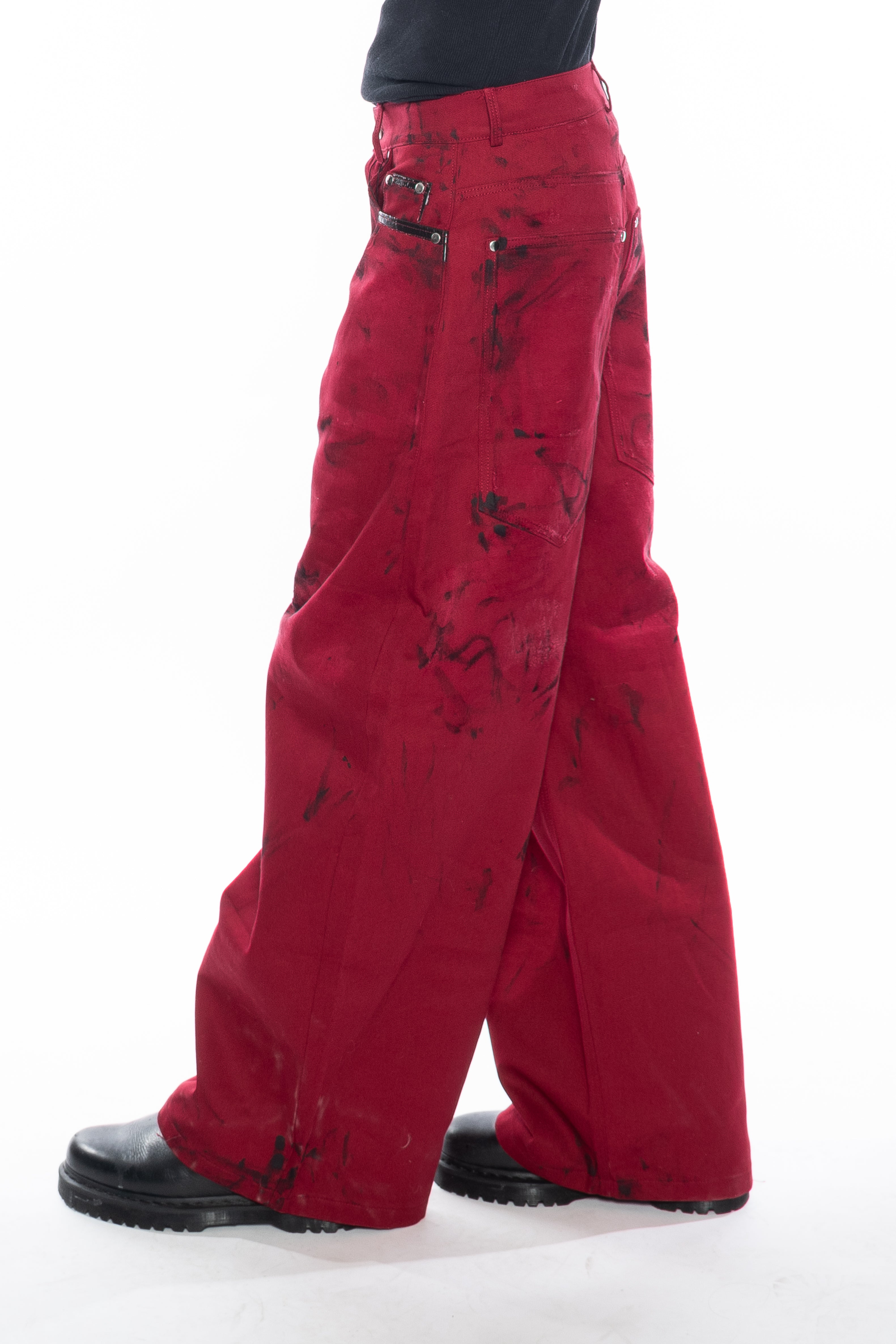 RED HAND-DYED OVERSIZED CURVED-LEG JEANS WITH A LOW-RISE WAIST, BLACK HAND-PAINTED DETAILS, FIVE-POCKET CONSTRUCTION, BUTTON FLY AND SILVER HARDWARE.