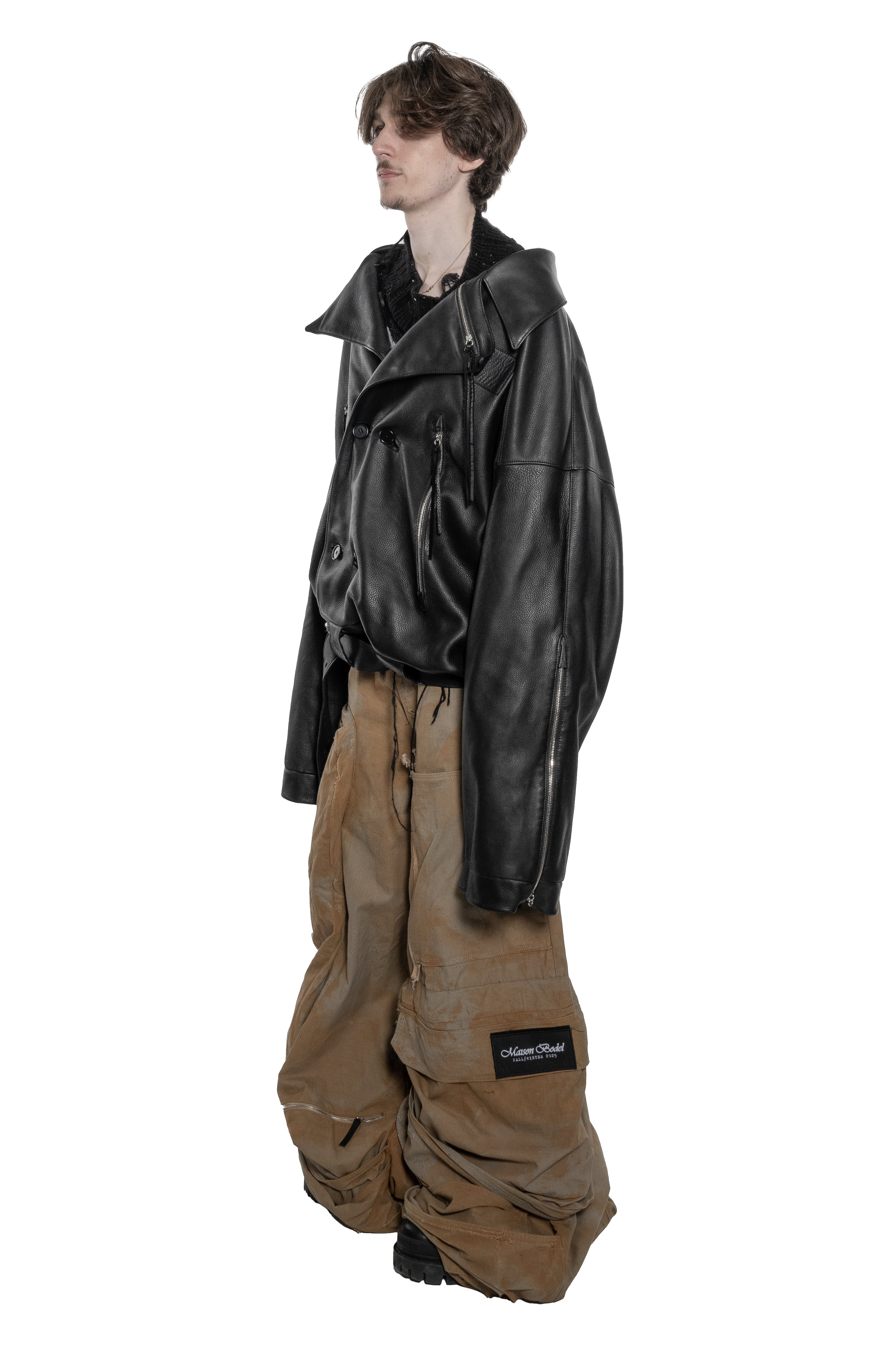 BLACK OVERSIZED LEATHER BIKER JACKET WITH DOUBLE-BREASTED CLOSURE, ASYMMETRICAL LAPELS, MULTIPLE ZIPPED POCKETS, ADJUSTABLE WAIST BELT AND SILVER HARDWARE.