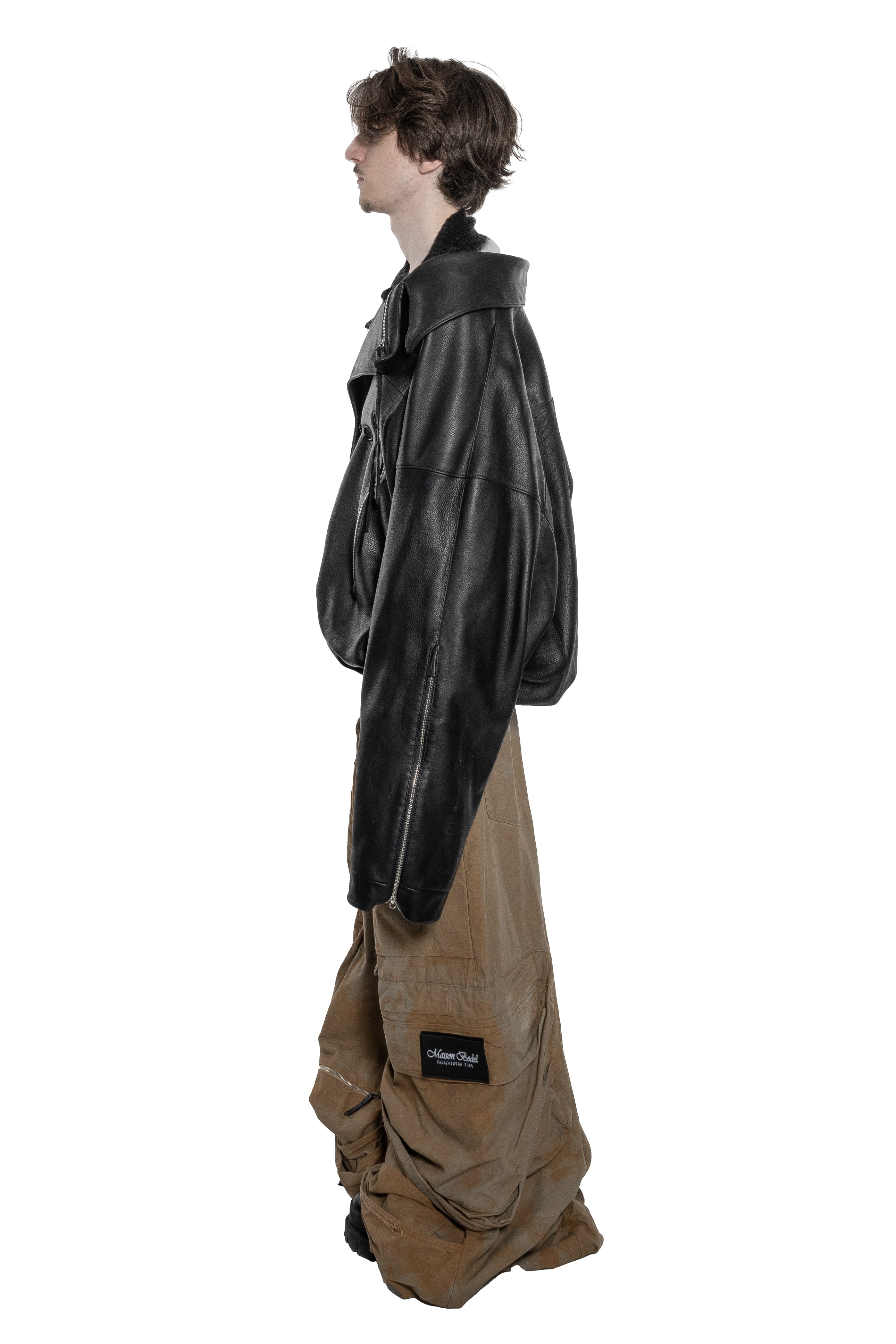 BLACK OVERSIZED LEATHER BIKER JACKET WITH DOUBLE-BREASTED CLOSURE, ASYMMETRICAL LAPELS, MULTIPLE ZIPPED POCKETS, ADJUSTABLE WAIST BELT AND SILVER HARDWARE.