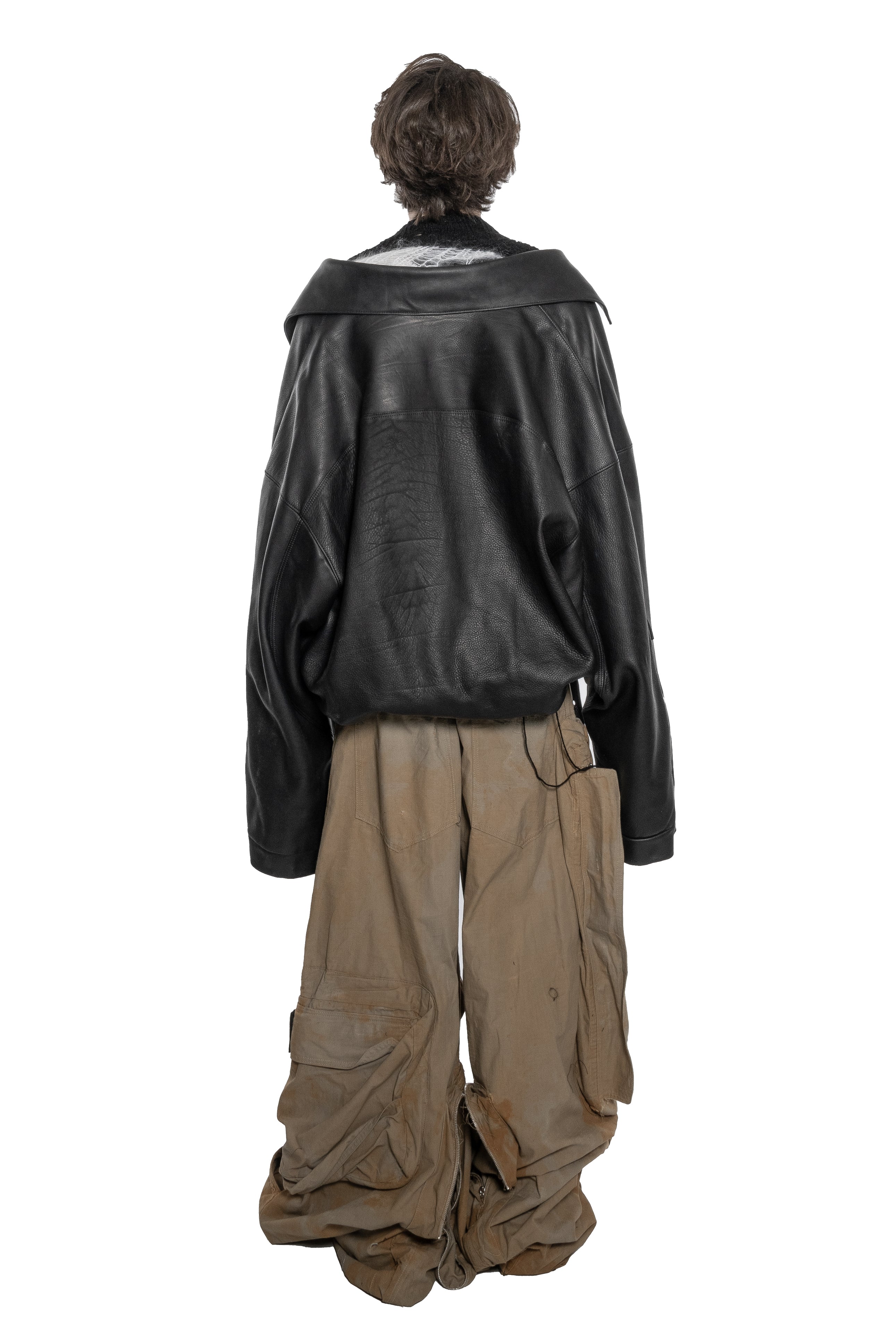 BLACK OVERSIZED LEATHER BIKER JACKET WITH DOUBLE-BREASTED CLOSURE, ASYMMETRICAL LAPELS, MULTIPLE ZIPPED POCKETS, ADJUSTABLE WAIST BELT AND SILVER HARDWARE.