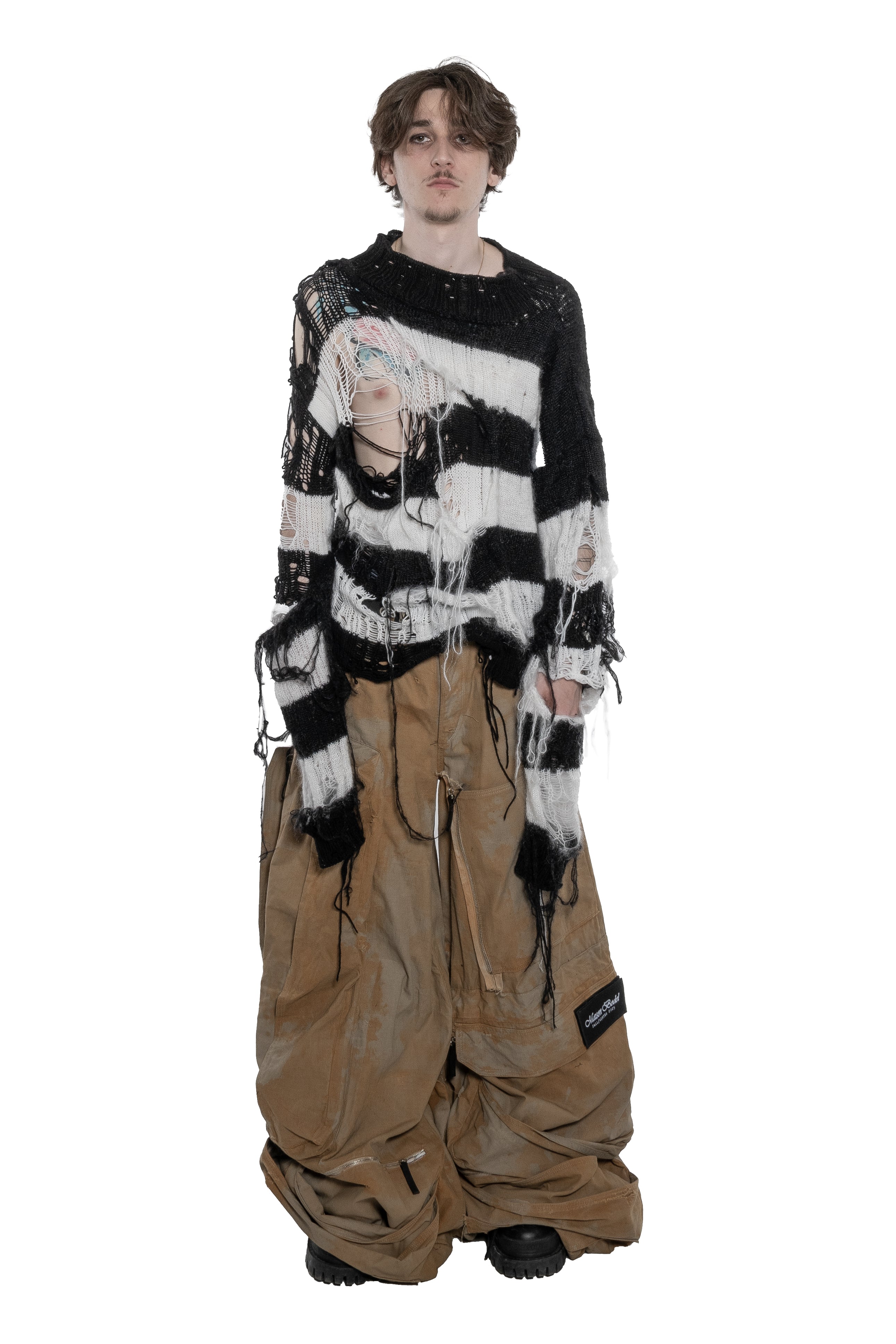 BLACK AND WHITE DISTRESSED STRIPED KNIT SWEATER WITH HAND-FRAYED DETAILS, OVERSIZED FIT, OPEN-KNIT CONSTRUCTION, LONG HANGING THREADS AND RAW FINISHES.