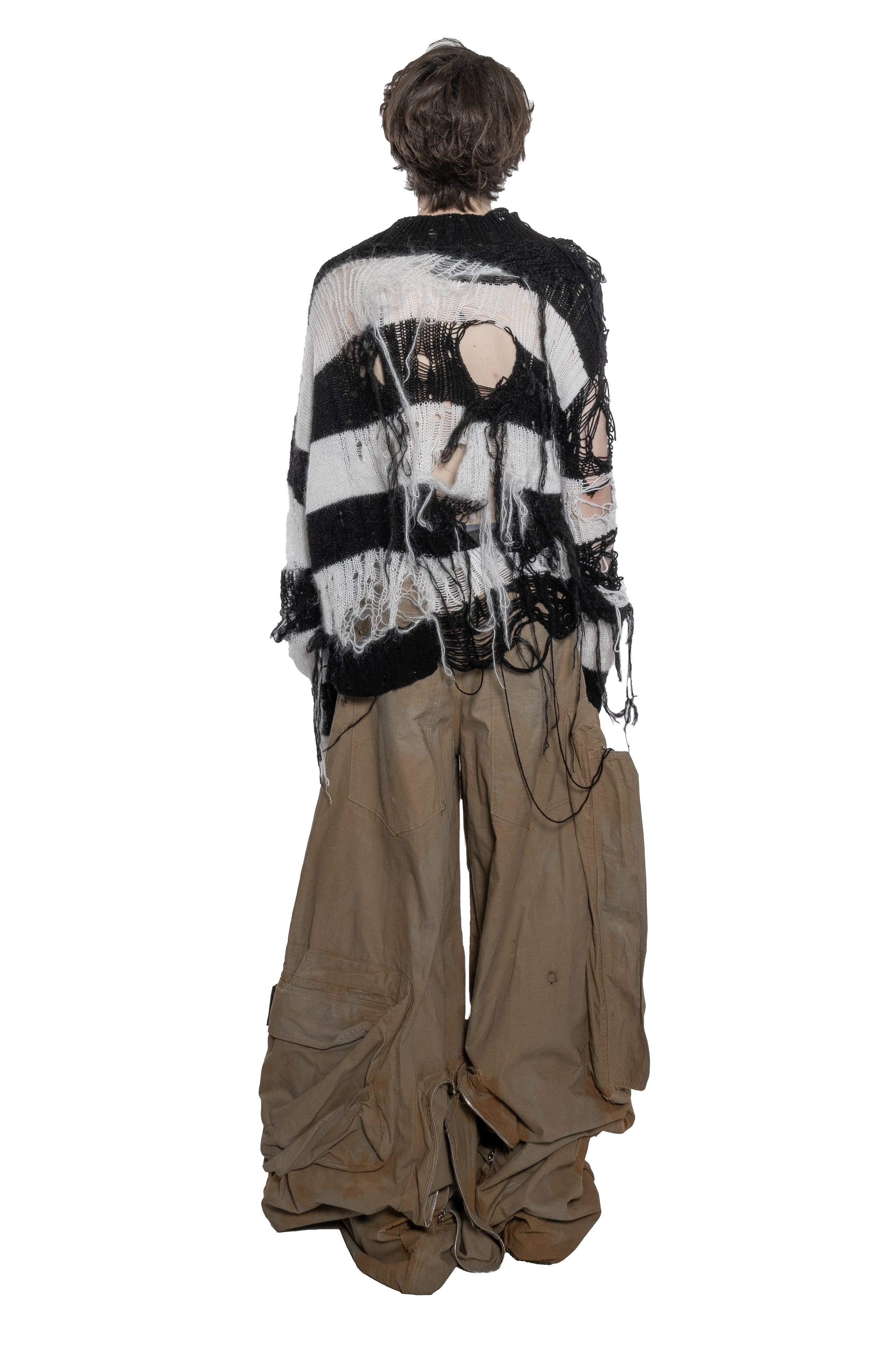 BLACK AND WHITE DISTRESSED STRIPED KNIT SWEATER WITH HAND-FRAYED DETAILS, OVERSIZED FIT, OPEN-KNIT CONSTRUCTION, LONG HANGING THREADS AND RAW FINISHES.