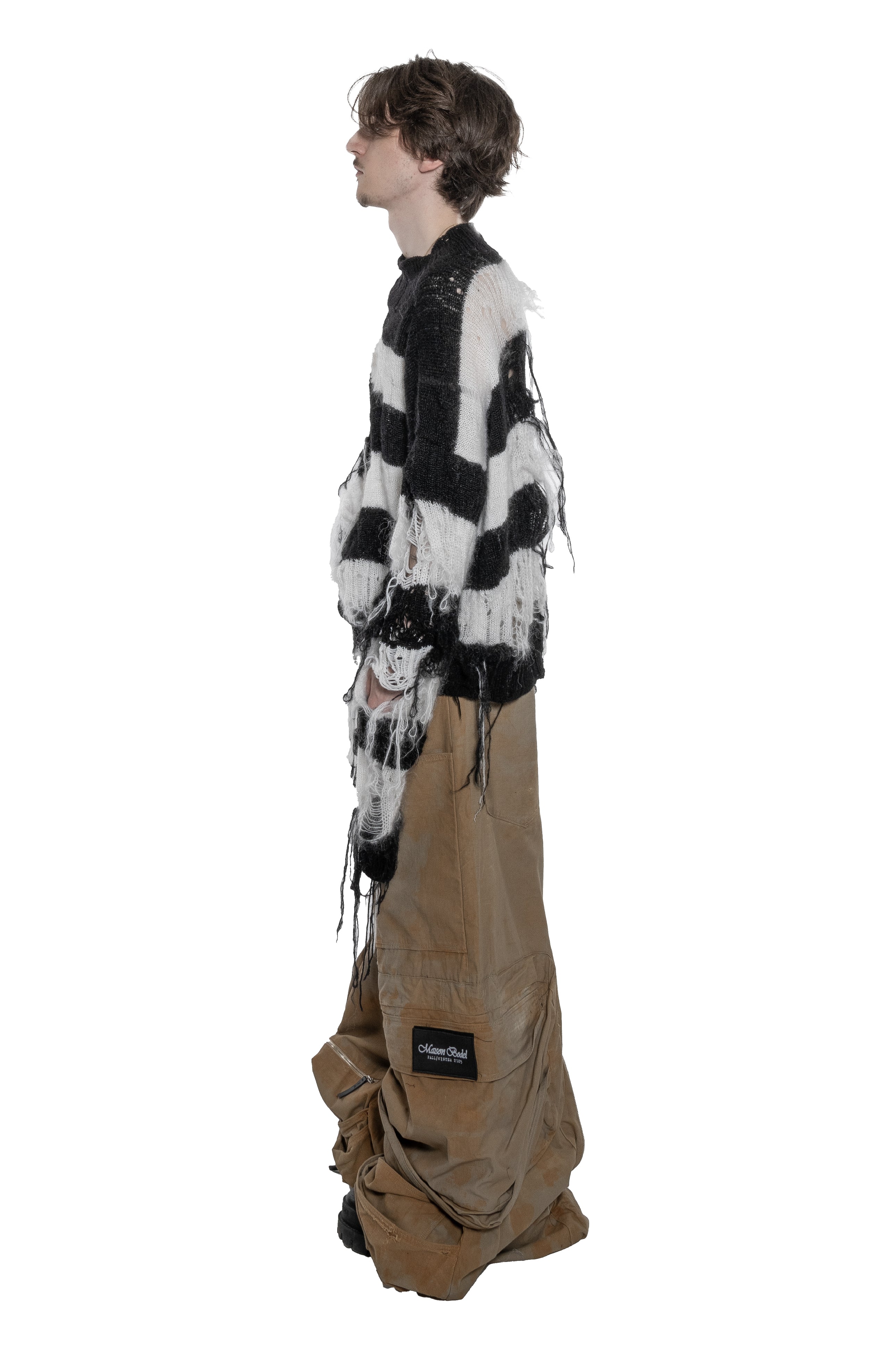 BLACK AND WHITE DISTRESSED STRIPED KNIT SWEATER WITH HAND-FRAYED DETAILS, OVERSIZED FIT, OPEN-KNIT CONSTRUCTION, LONG HANGING THREADS AND RAW FINISHES.