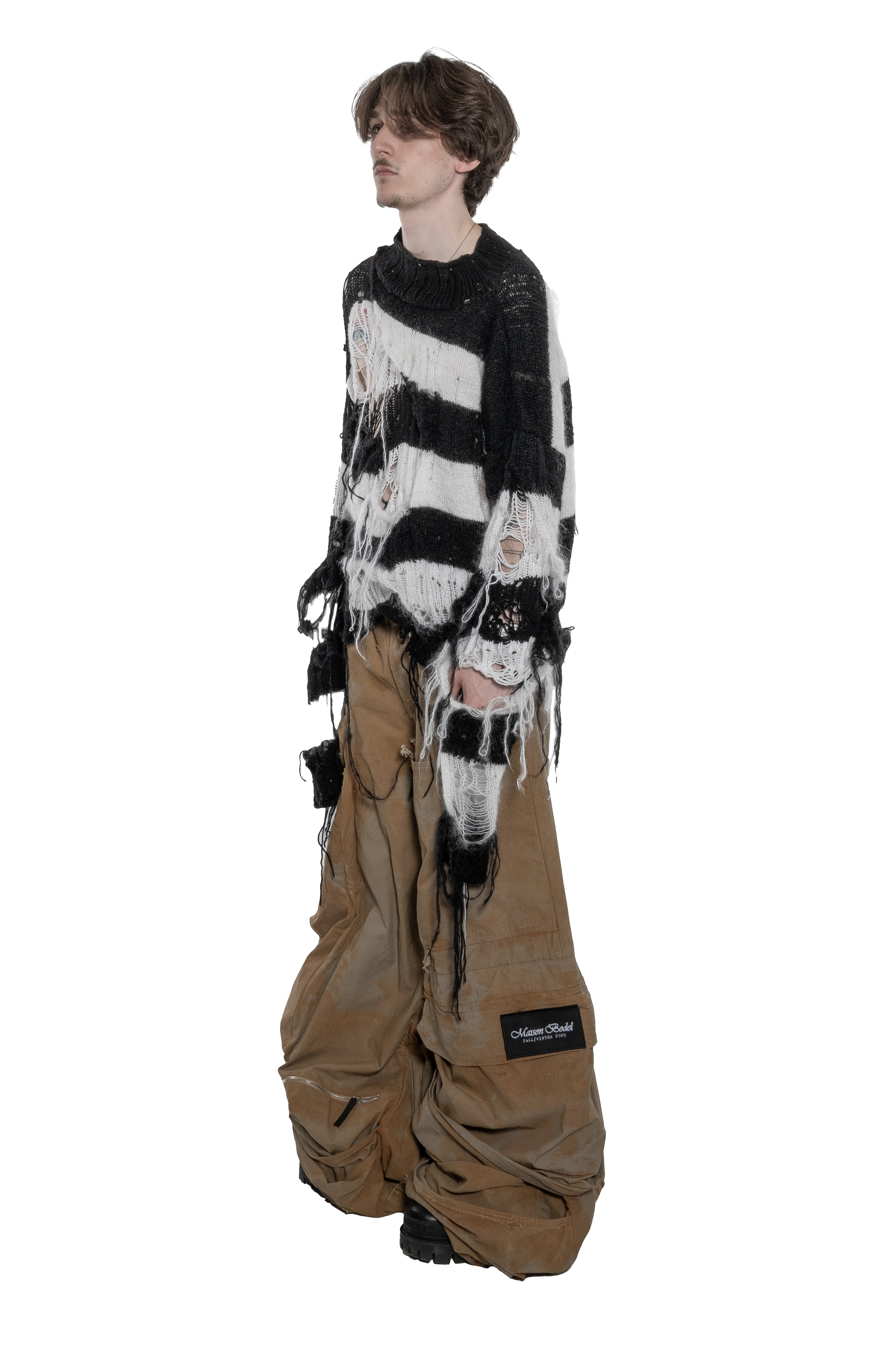 BLACK AND WHITE DISTRESSED STRIPED KNIT SWEATER WITH HAND-FRAYED DETAILS, OVERSIZED FIT, OPEN-KNIT CONSTRUCTION, LONG HANGING THREADS AND RAW FINISHES.