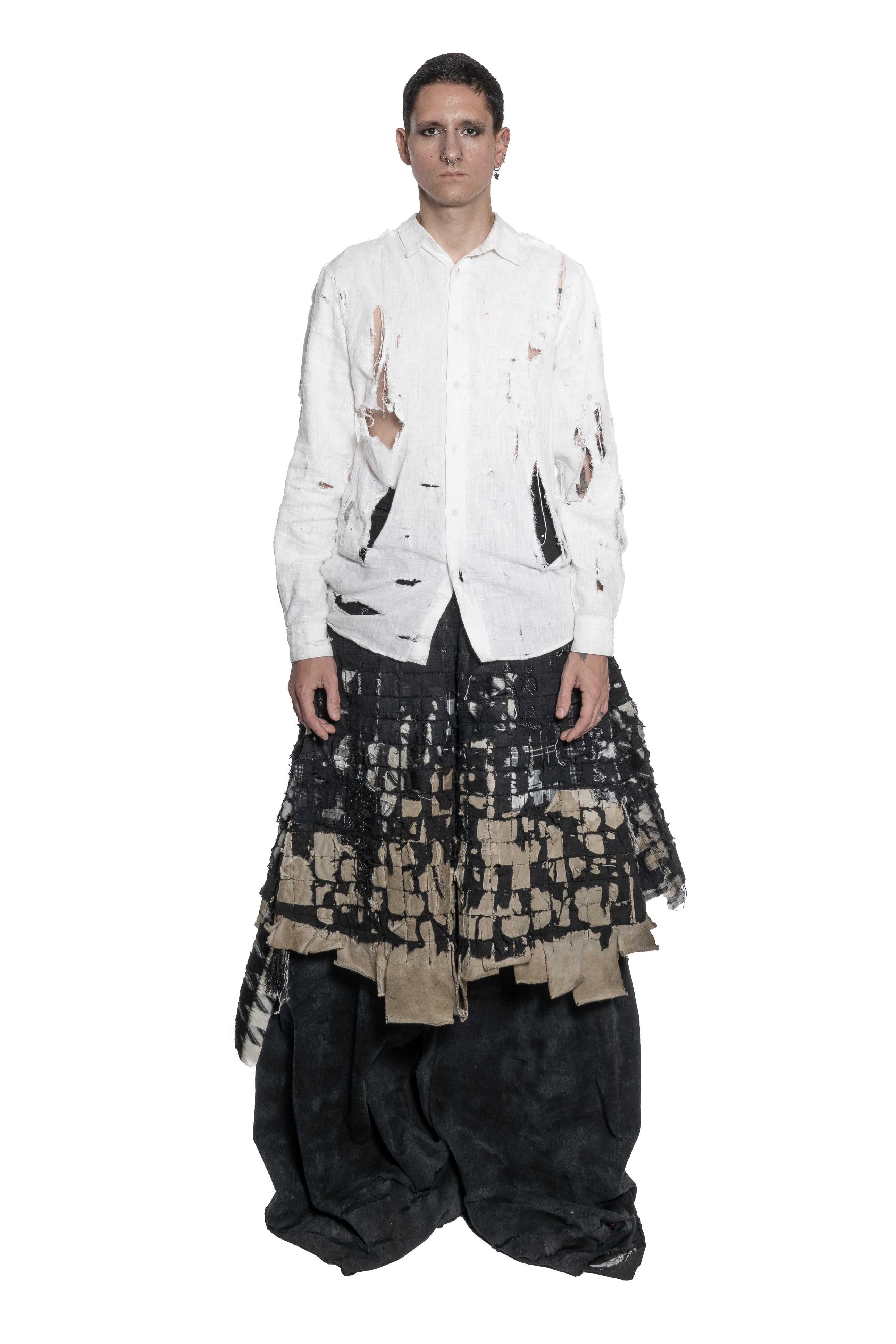 BLACK LAYERED DISTRESSED SKIRT WITH HAND-FRAYED DETAILS, PATCHWORK CONSTRUCTION, ASYMMETRICAL HEM.