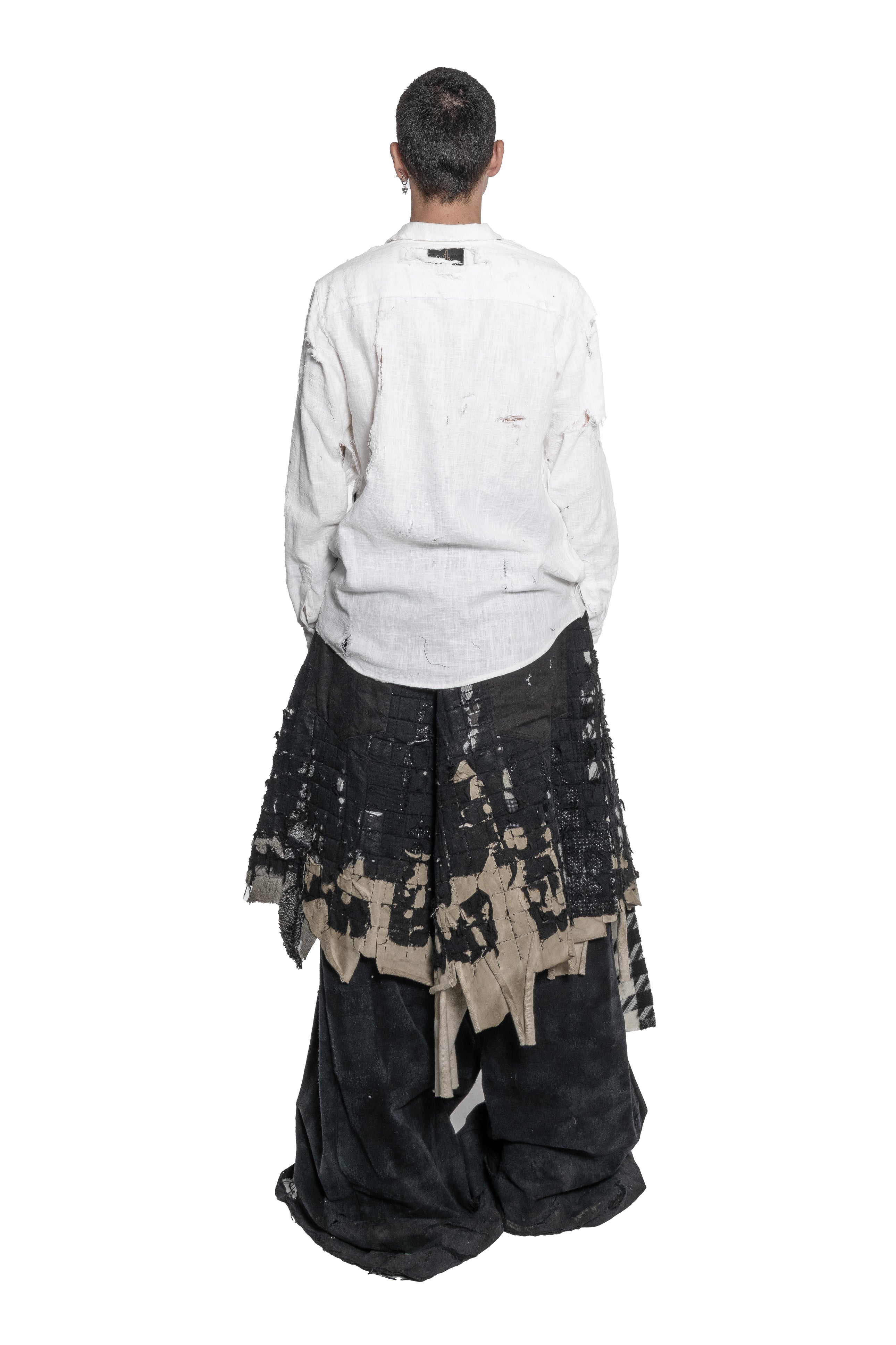 BLACK LAYERED DISTRESSED SKIRT WITH HAND-FRAYED DETAILS, PATCHWORK CONSTRUCTION, ASYMMETRICAL HEM.