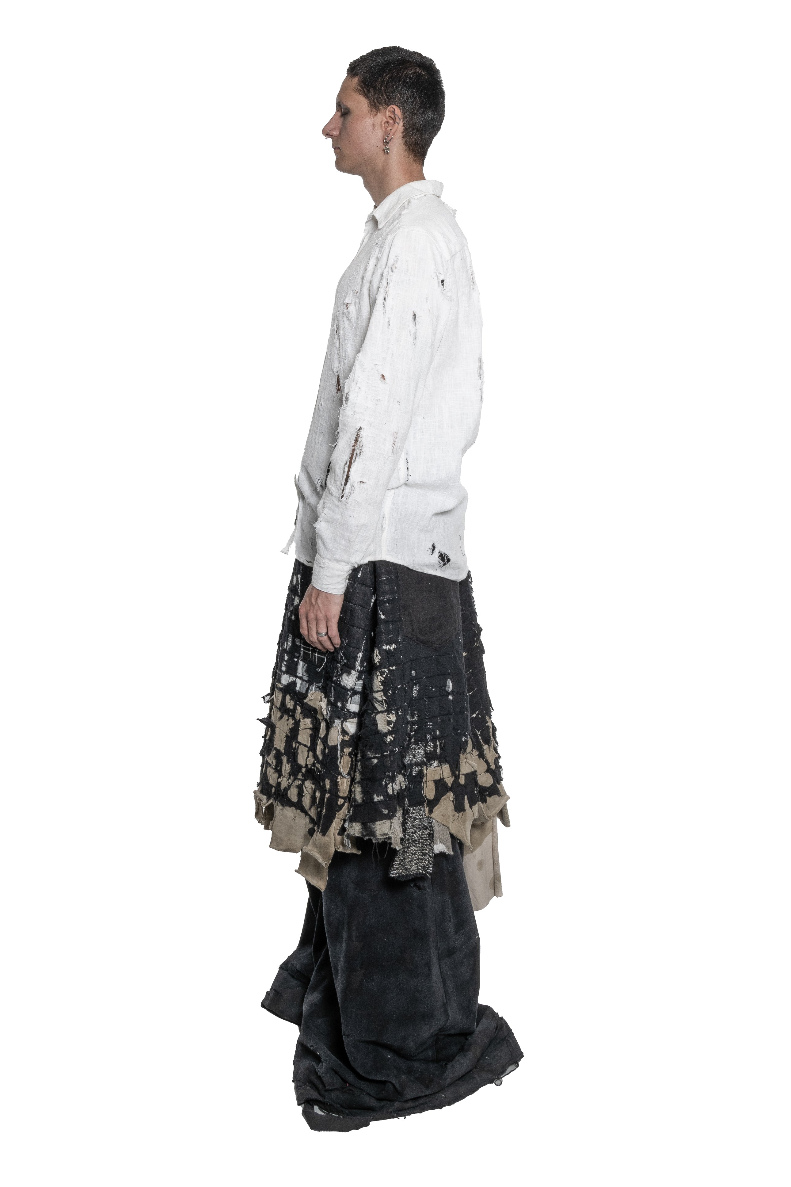 BLACK LAYERED DISTRESSED SKIRT WITH HAND-FRAYED DETAILS, PATCHWORK CONSTRUCTION, ASYMMETRICAL HEM.