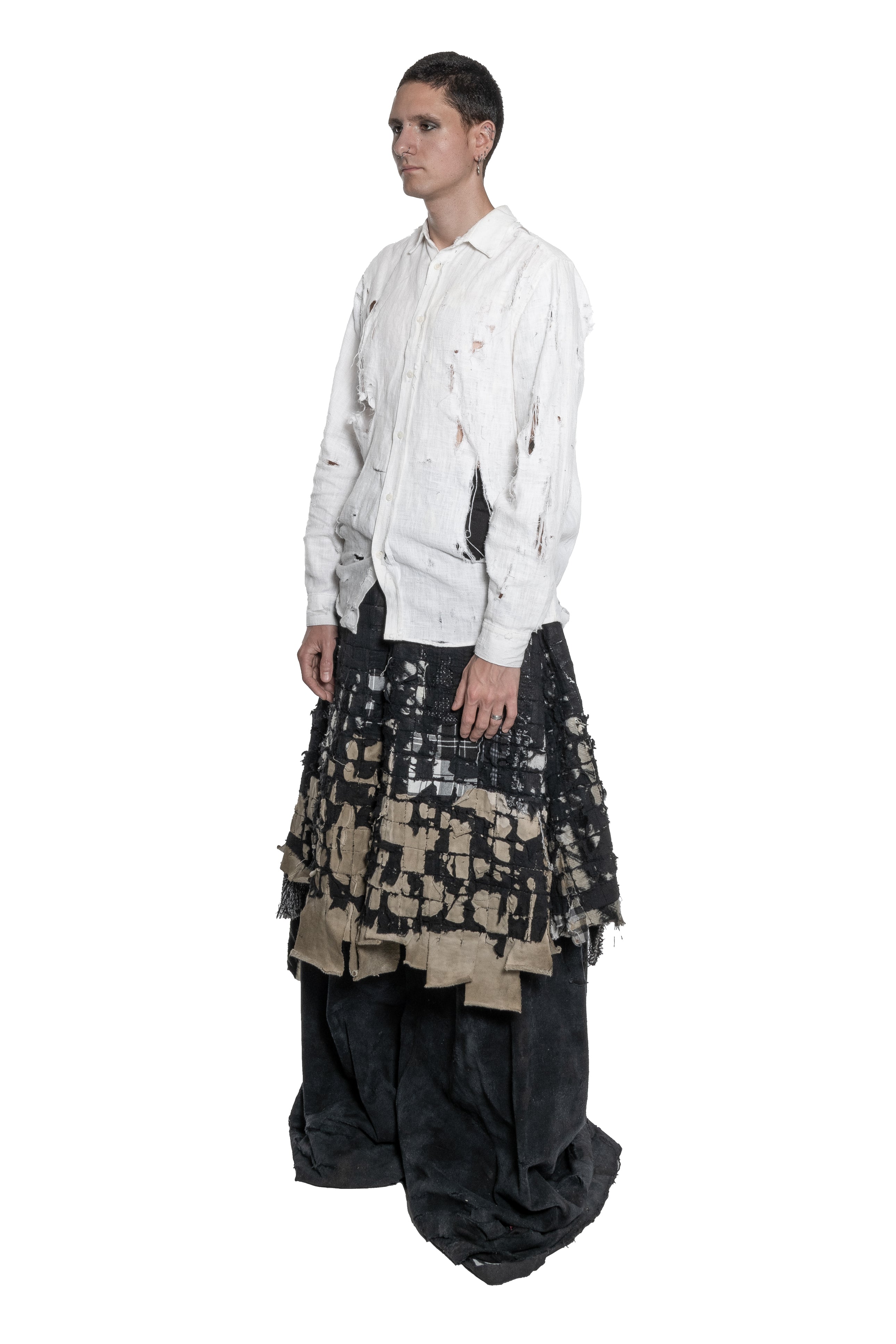 BLACK LAYERED DISTRESSED SKIRT WITH HAND-FRAYED DETAILS, PATCHWORK CONSTRUCTION, ASYMMETRICAL HEM.