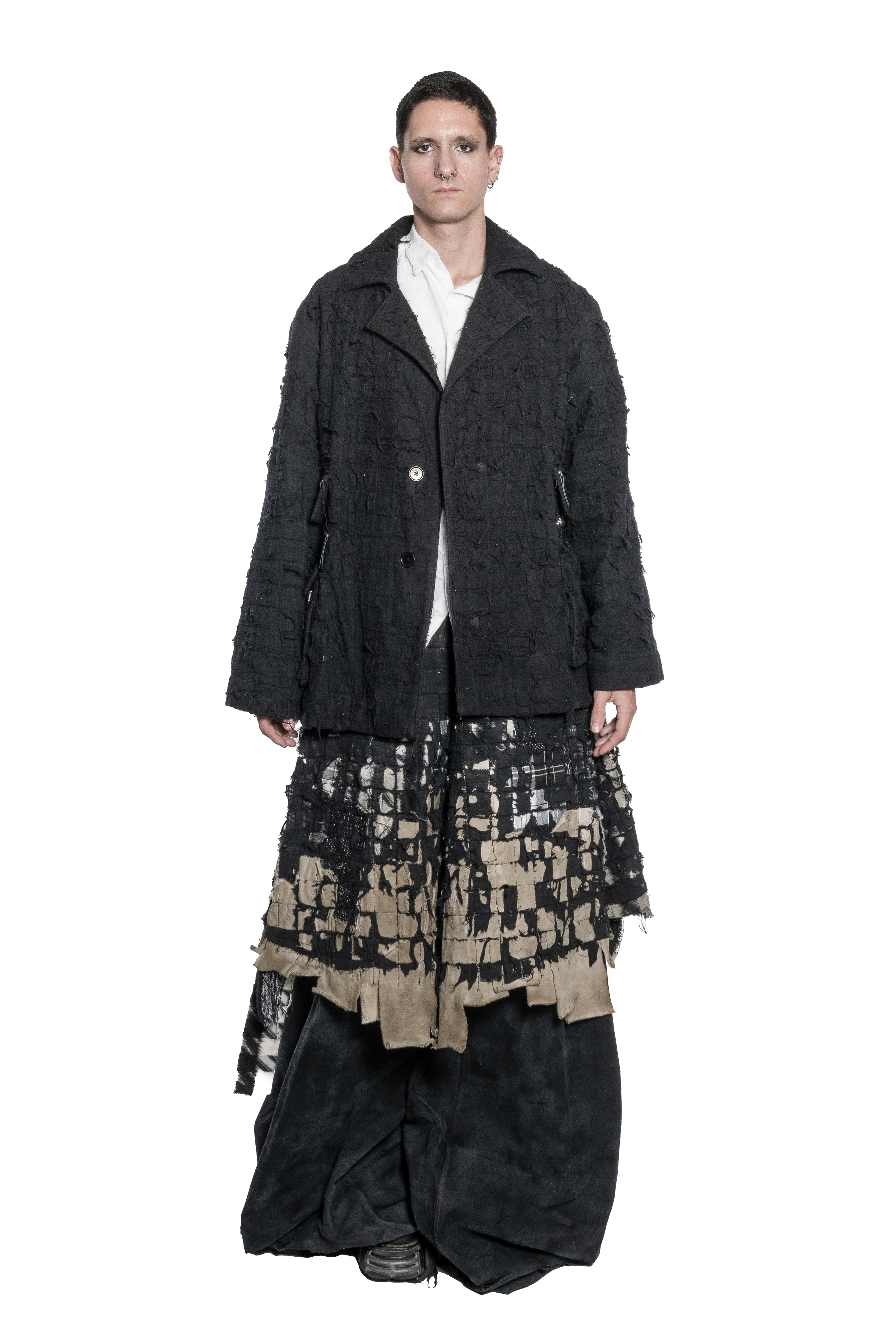 BLACK DISTRESSED TAILORED JACKET WITH FRAYED TEXTURE, OVERSIZED SILHOUETTE, MULTIPLE ZIPPED PATCH POCKETS, BUTTON FRONT CLOSURE AND RAW FINISHES.