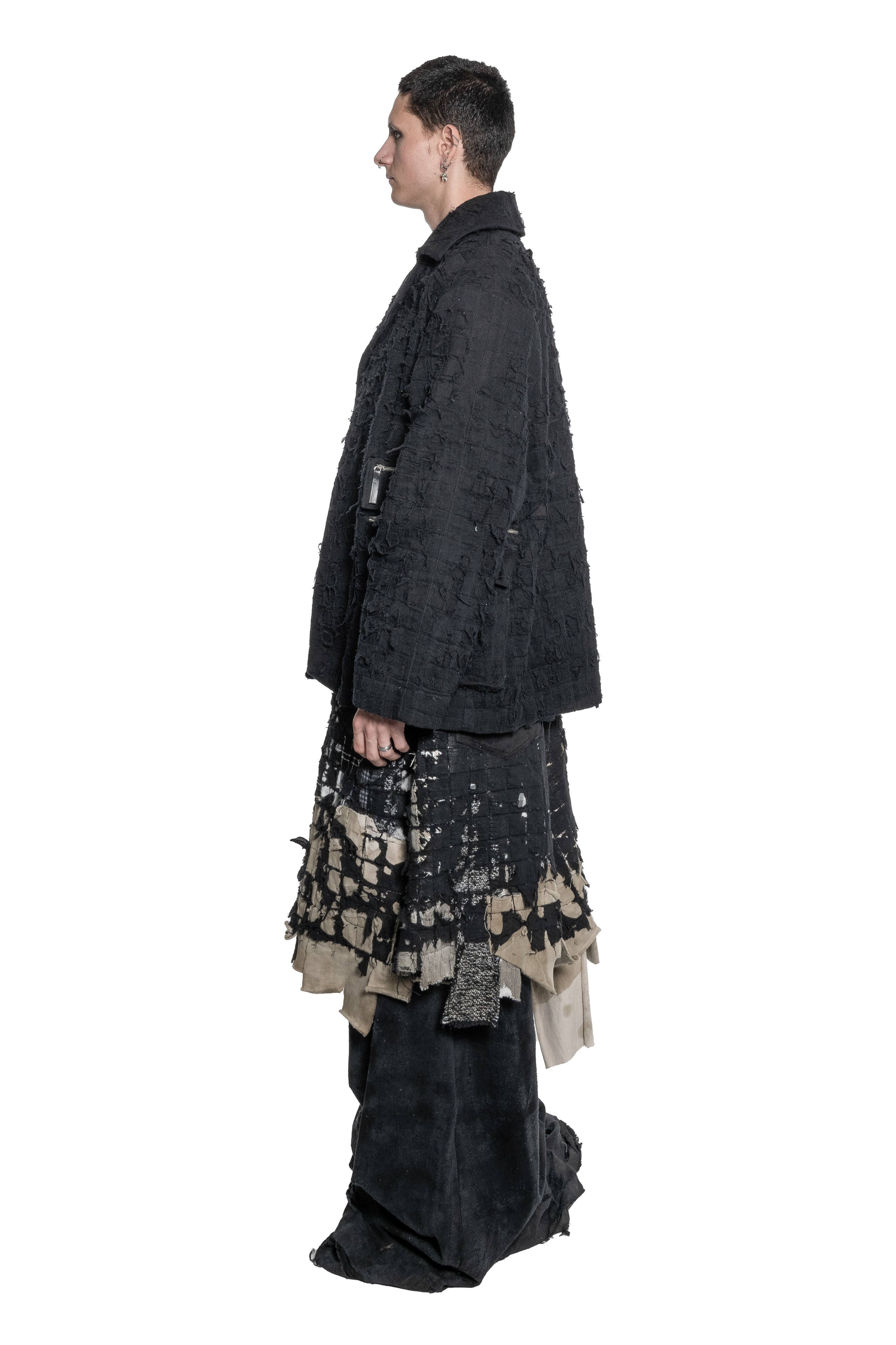 BLACK DISTRESSED TAILORED JACKET WITH FRAYED TEXTURE, OVERSIZED SILHOUETTE, MULTIPLE ZIPPED PATCH POCKETS, BUTTON FRONT CLOSURE AND RAW FINISHES.