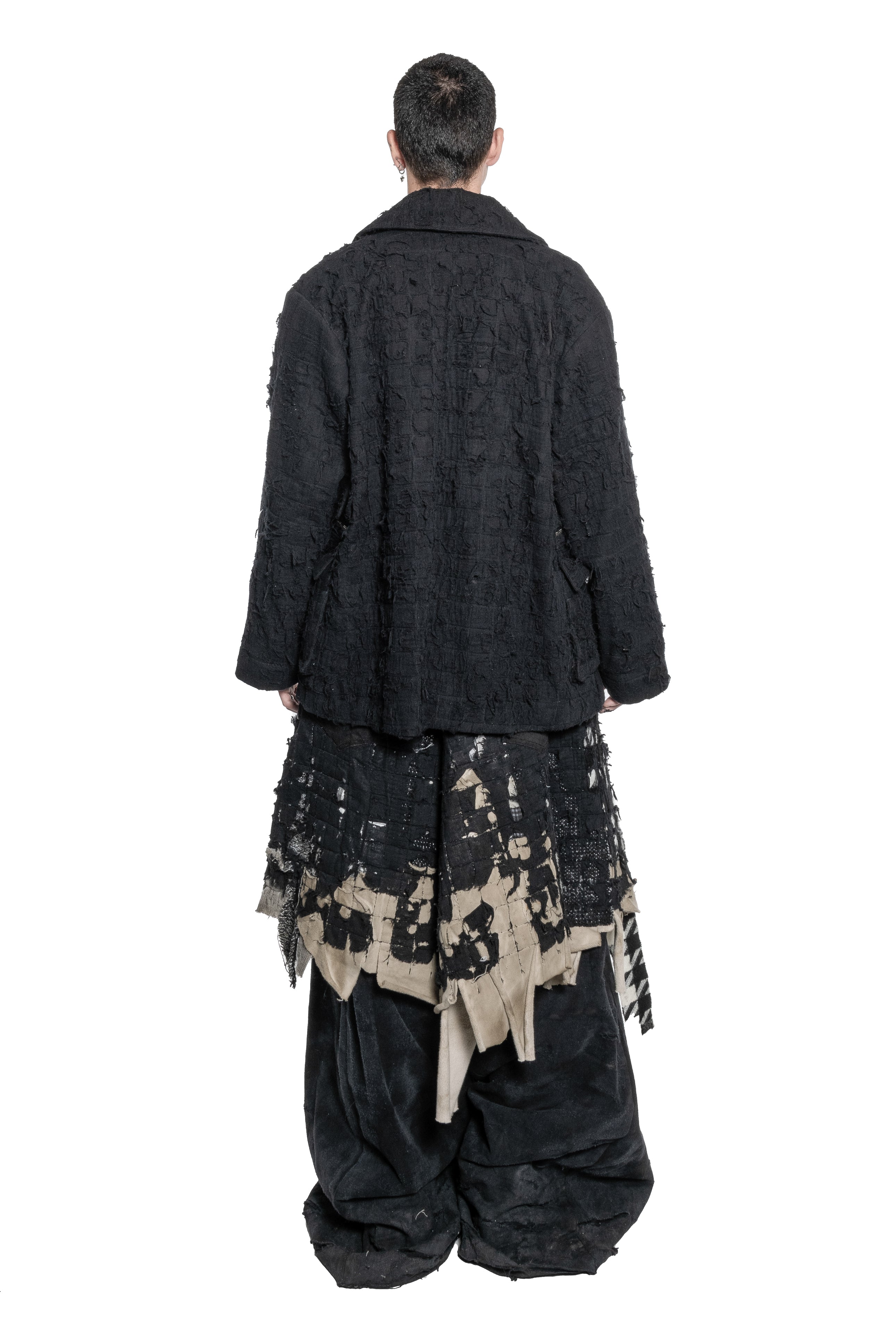 BLACK DISTRESSED TAILORED JACKET WITH FRAYED TEXTURE, OVERSIZED SILHOUETTE, MULTIPLE ZIPPED PATCH POCKETS, BUTTON FRONT CLOSURE AND RAW FINISHES.